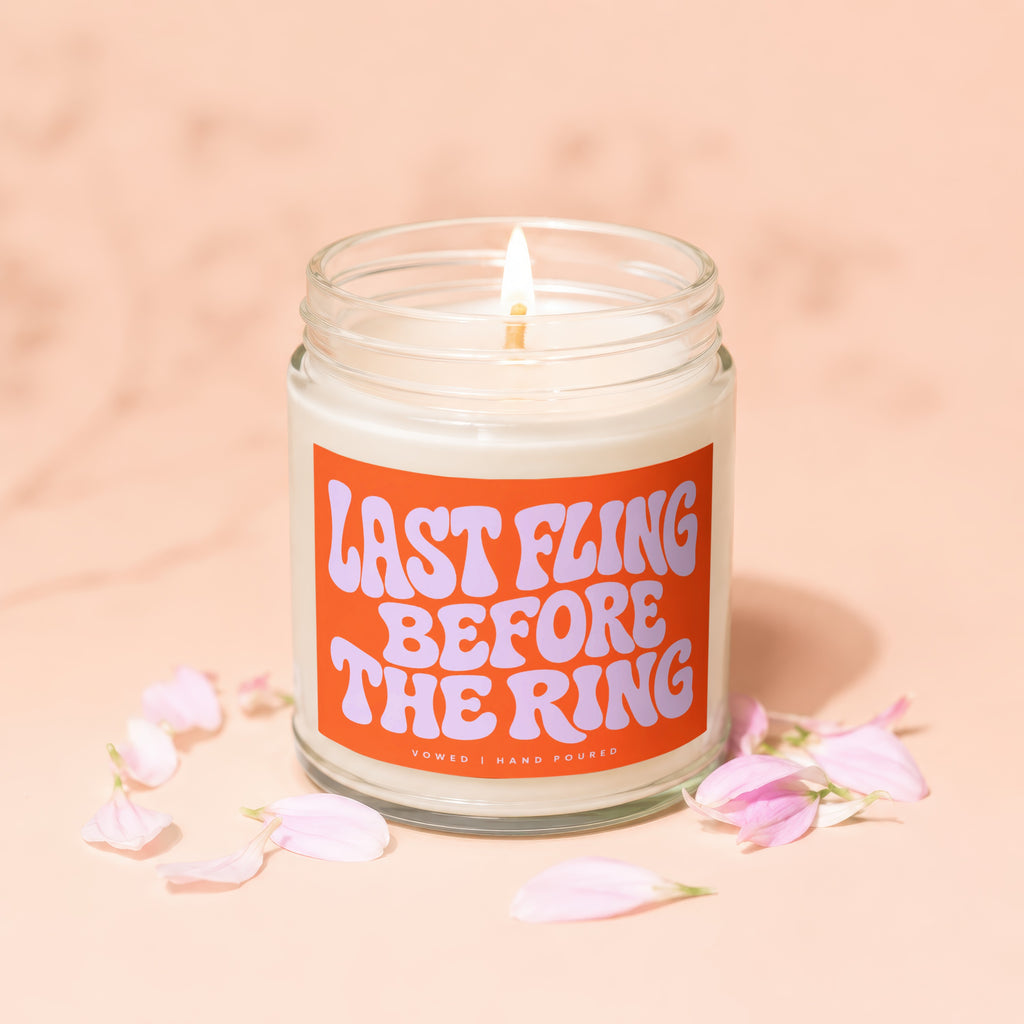 Lit candle with orange label reading "LAST FLING BEFORE THE RING."