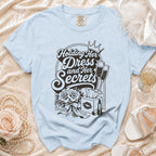 Light blue Comfort Colors t-shirt graphic: "Holding Her Dress and Her Secrets"
