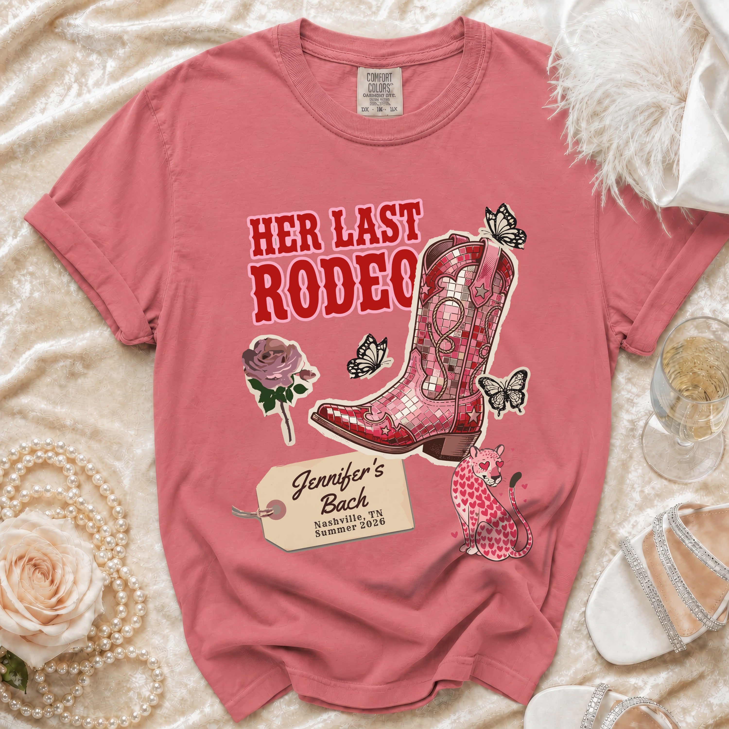 Pink graphic t-shirt with "Her Last Rodeo" text, cowboy boot, and butterflies.