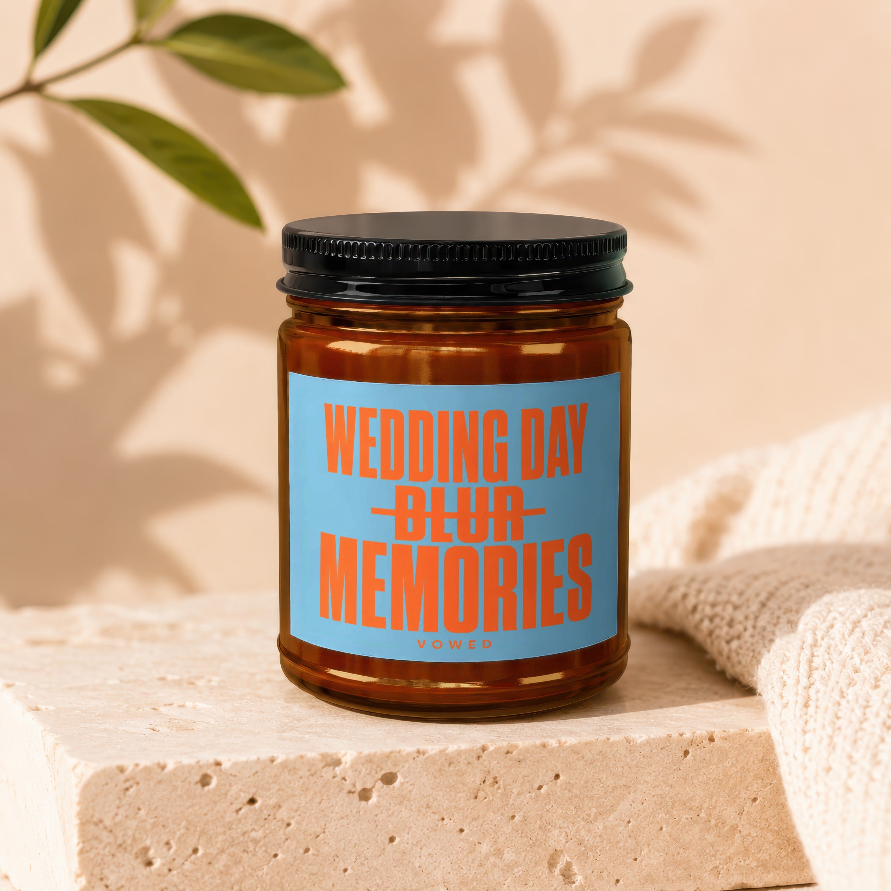 Amber jar candle with a blue label reading "WEDDING DAY BLUR MEMORIES VOWED".