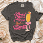 Grey t-shirt with pink text reading "Maid of Honour Needs a Mimosa" and graphic.