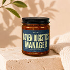 Amber jar with dark lid, label reads "Title: Coven Logistics Manager. Spreadsheets, Spells, Seating Charts. Vowed."