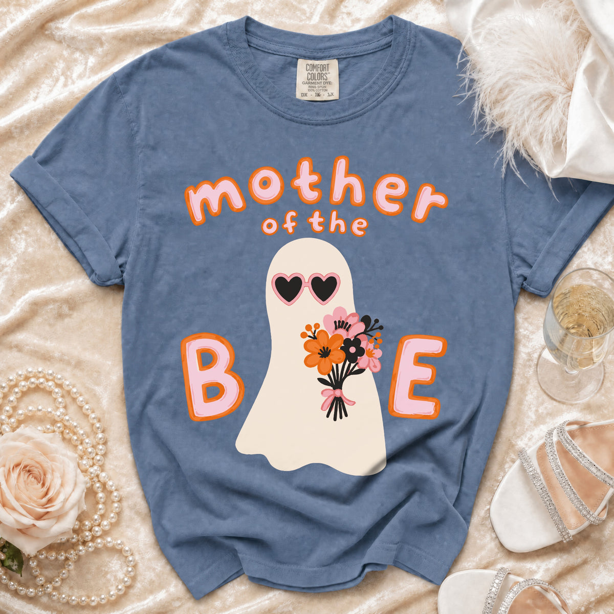 Blue t-shirt with ghost graphic saying "mother of the B E".