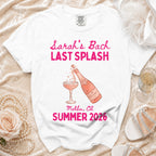 White t-shirt with pink text "Sarah's Bach LAST SPLASH" and champagne bottle.