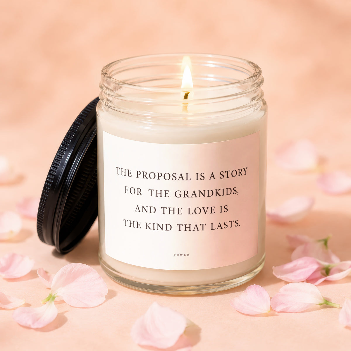 Candle with lit wick and text: "The proposal is a story for the grandkids, and the love is the kind that lasts. Vowed"