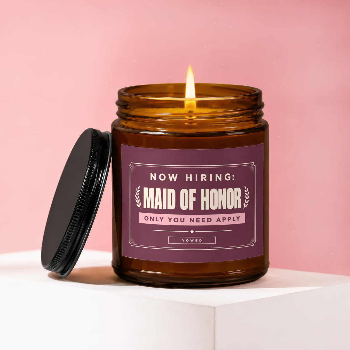 Amber jar candle with lid ajar, reads "Now Hiring: Maid of Honor" and "Vowed".
