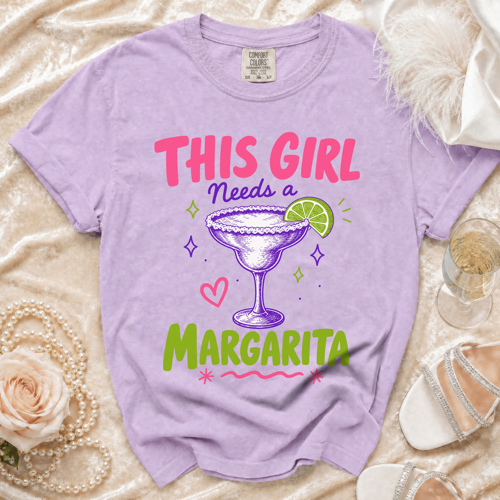 Purple t-shirt with "THIS GIRL NEEDS A MARGARITA" text and margarita graphic.
