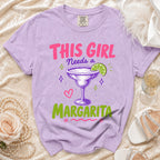 Purple t-shirt with "THIS GIRL NEEDS A MARGARITA" text and margarita graphic.