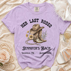T-shirt with "Her Last Rodeo" design, cowboy boots, and text.