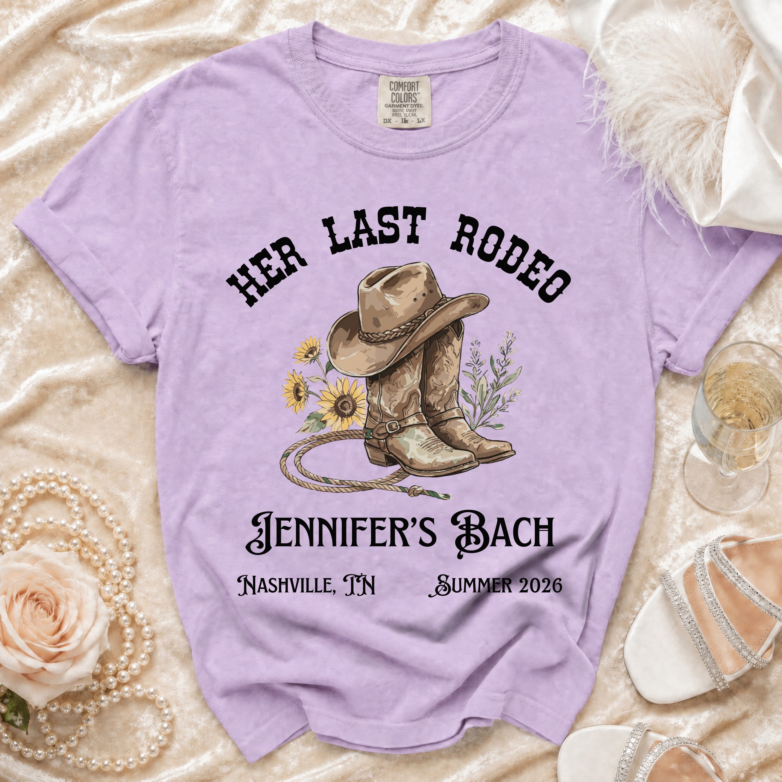 T-shirt with "Her Last Rodeo" design, cowboy boots, and text.