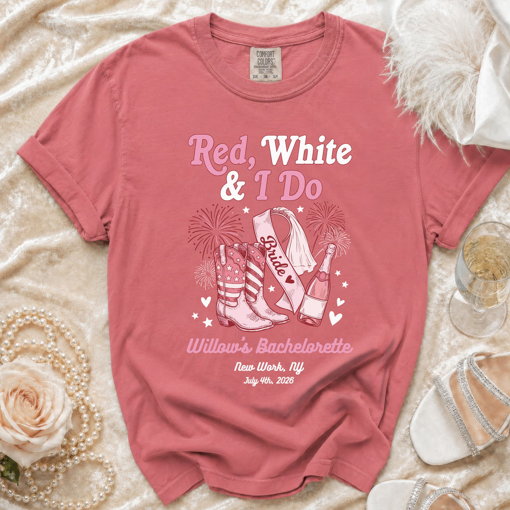 Pink t-shirt with "Red, White & I Do" text and bride, cowboy boot, and champagne graphics.