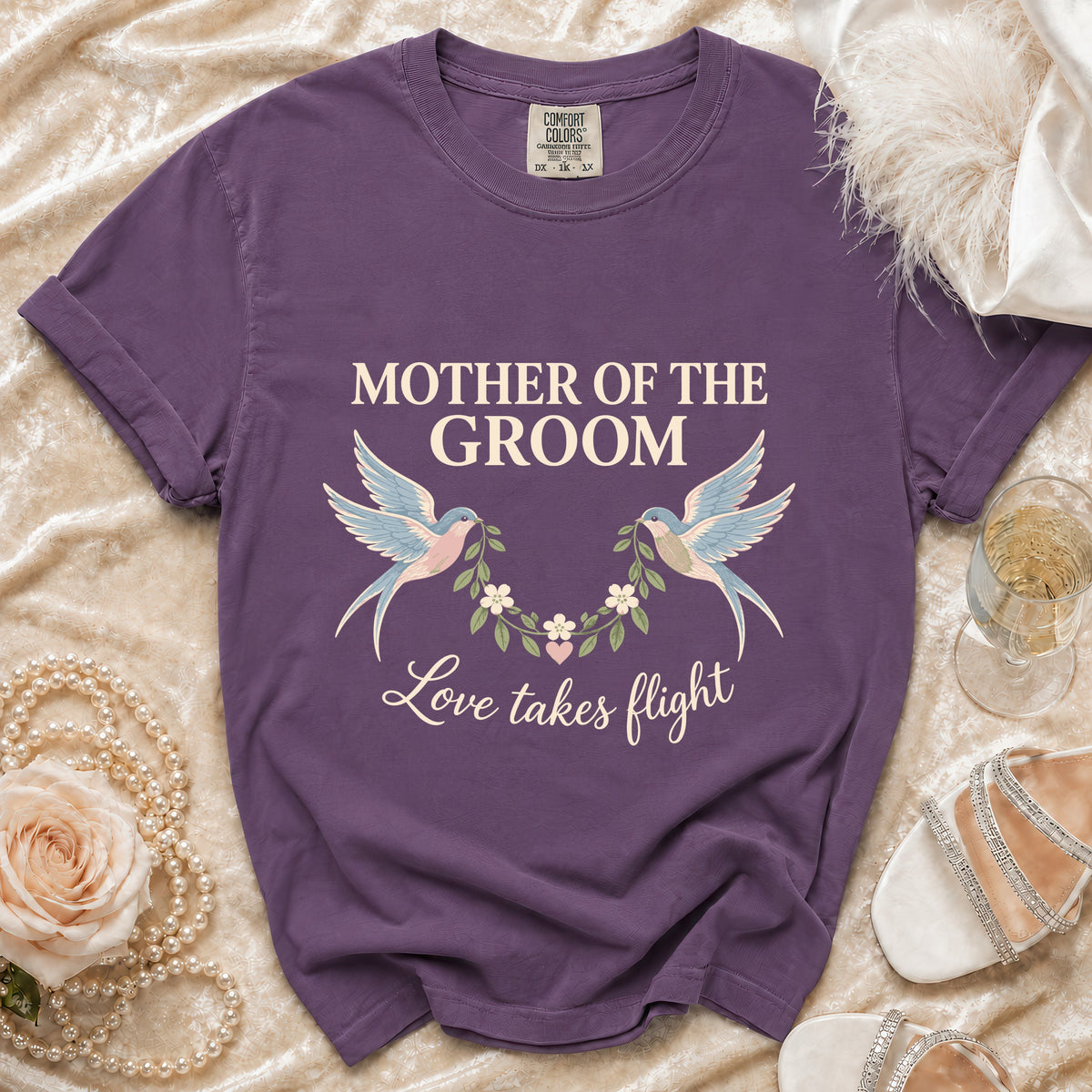 Purple t-shirt with "Mother of the Groom" and "Love takes flight" text.
