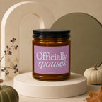 Amber candle with purple label reading "Officially spouses".