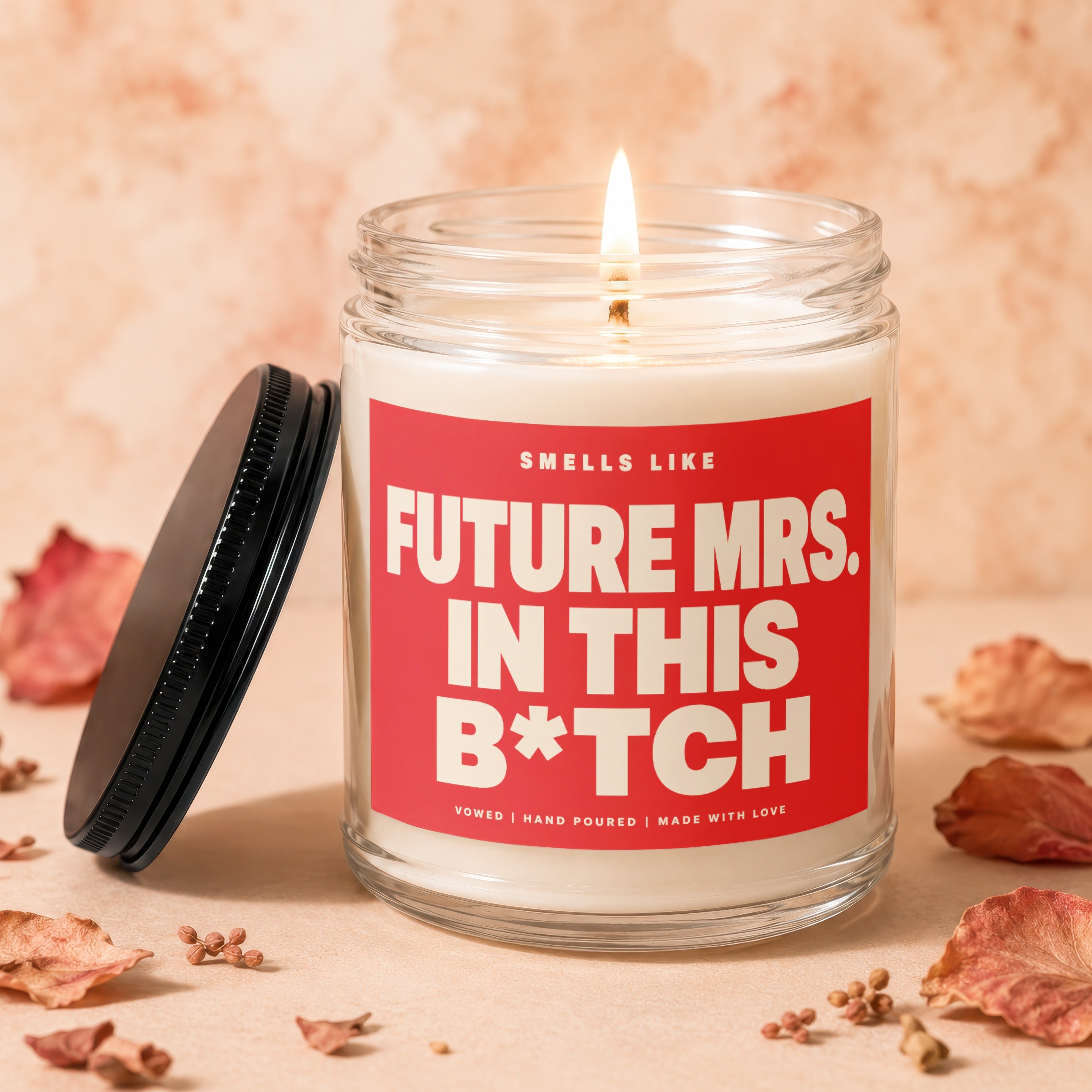 Candle with red label reading "Smells Like Future Mrs. in this B*tch".