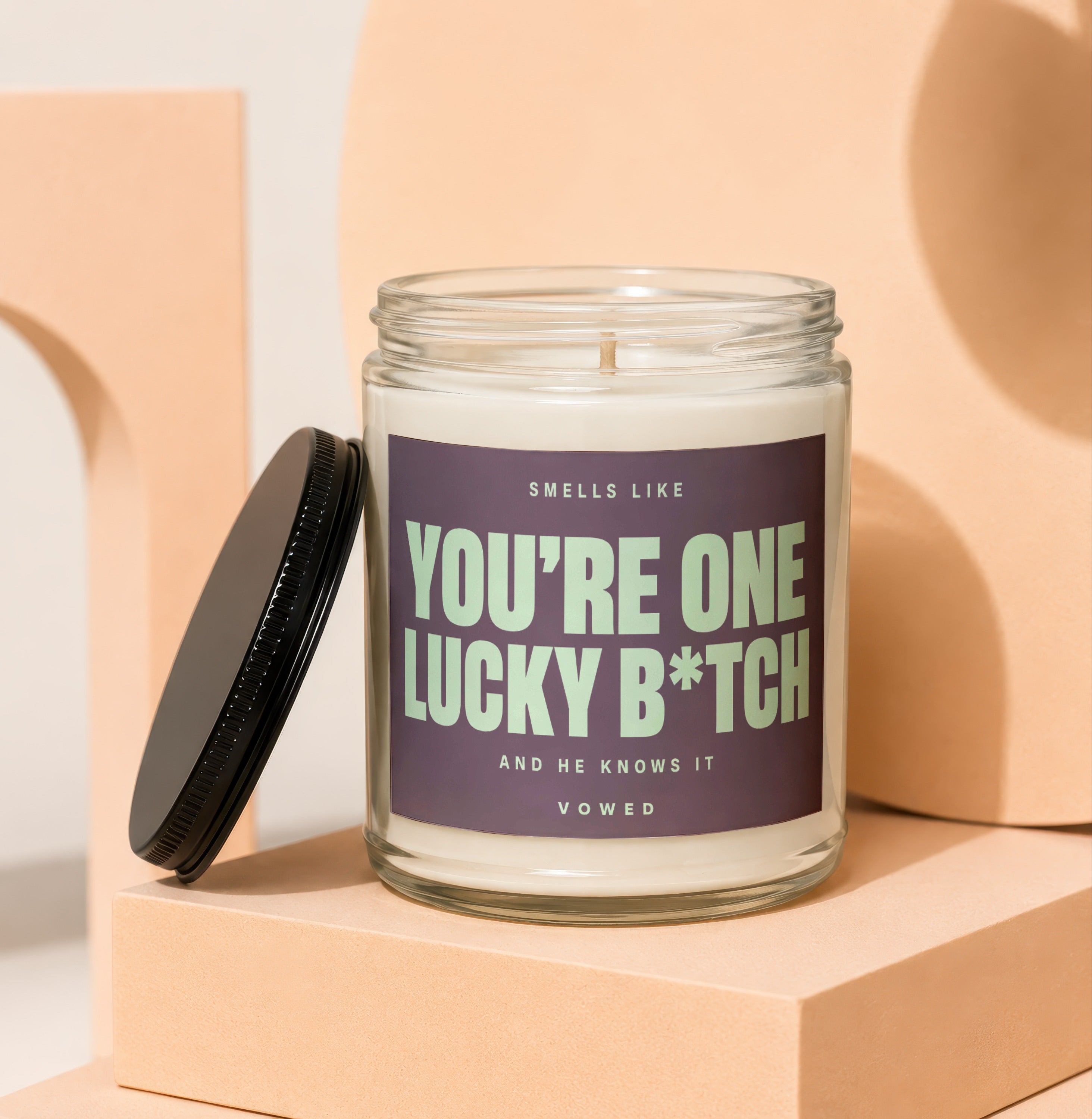Candle with text "You're One Lucky B*tch and He Knows It".