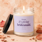 Lit candle with "Sienna, it's giving bridesmaid. say yes?" text and date on label.