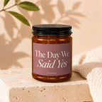 Amber jar candle with "The Day We Said Yes" text on a mauve label.