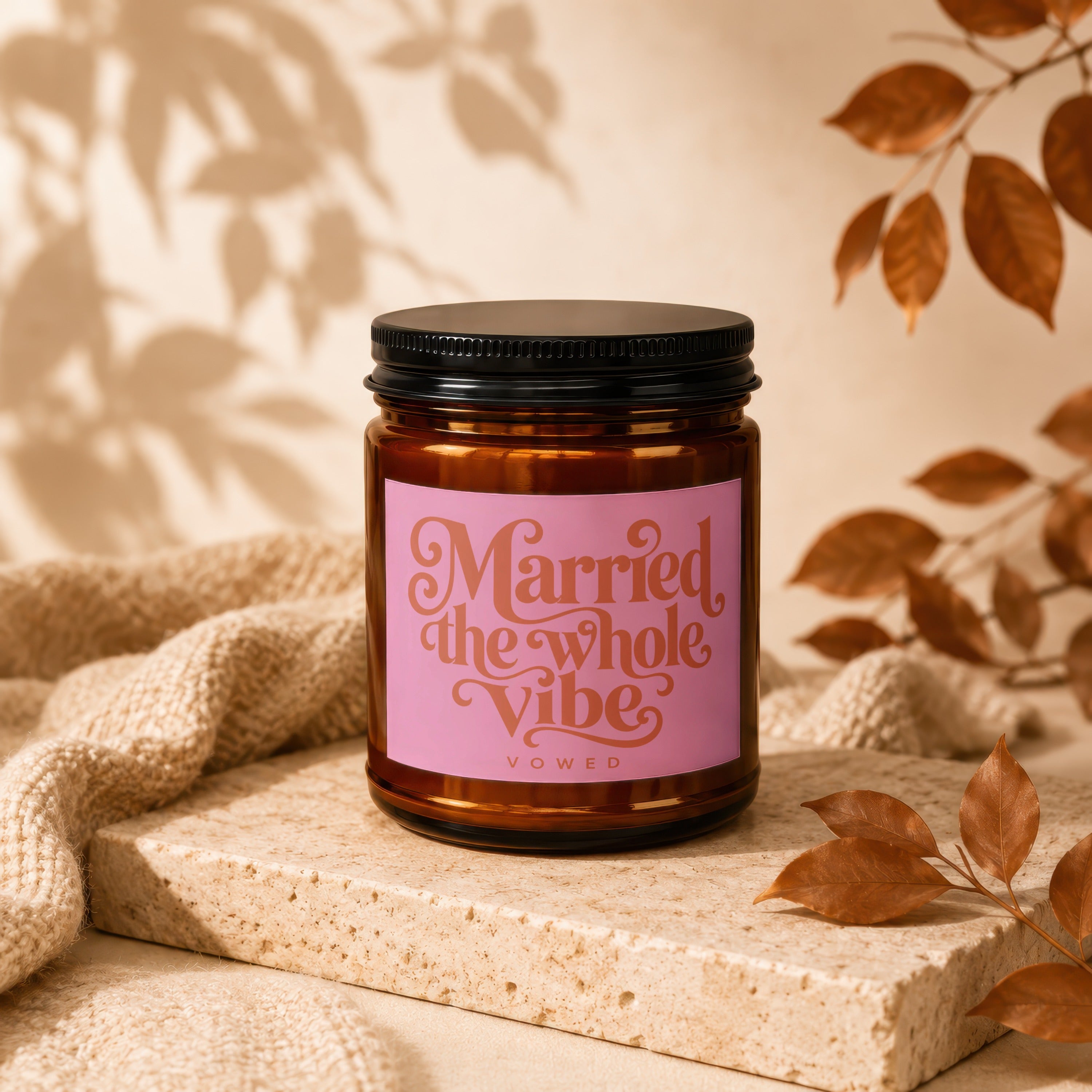 Amber candle with pink label reading "Married the whole Vibe VOWED".