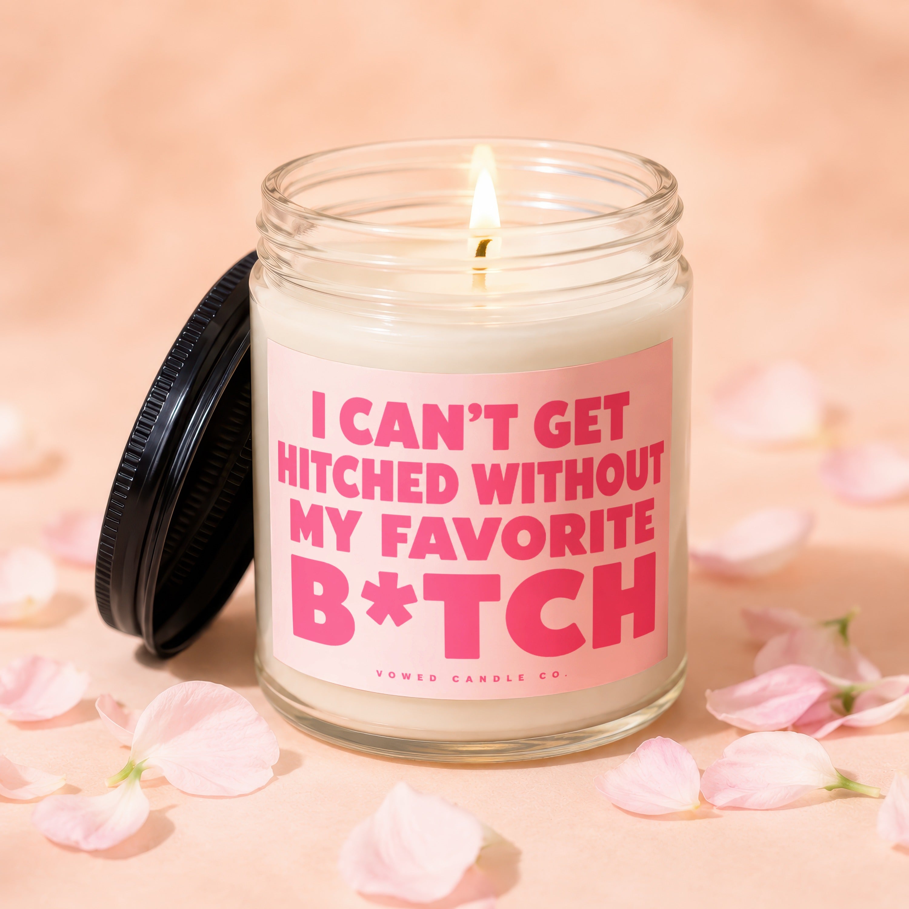 Glass candle with pink label that reads "I CAN'T GET HITCHED WITHOUT MY FAVORITE B*TCH".