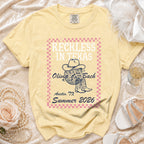 Yellow t-shirt with "Reckless in Texas Olivia Bach Austin, TX Summer 2026" text.