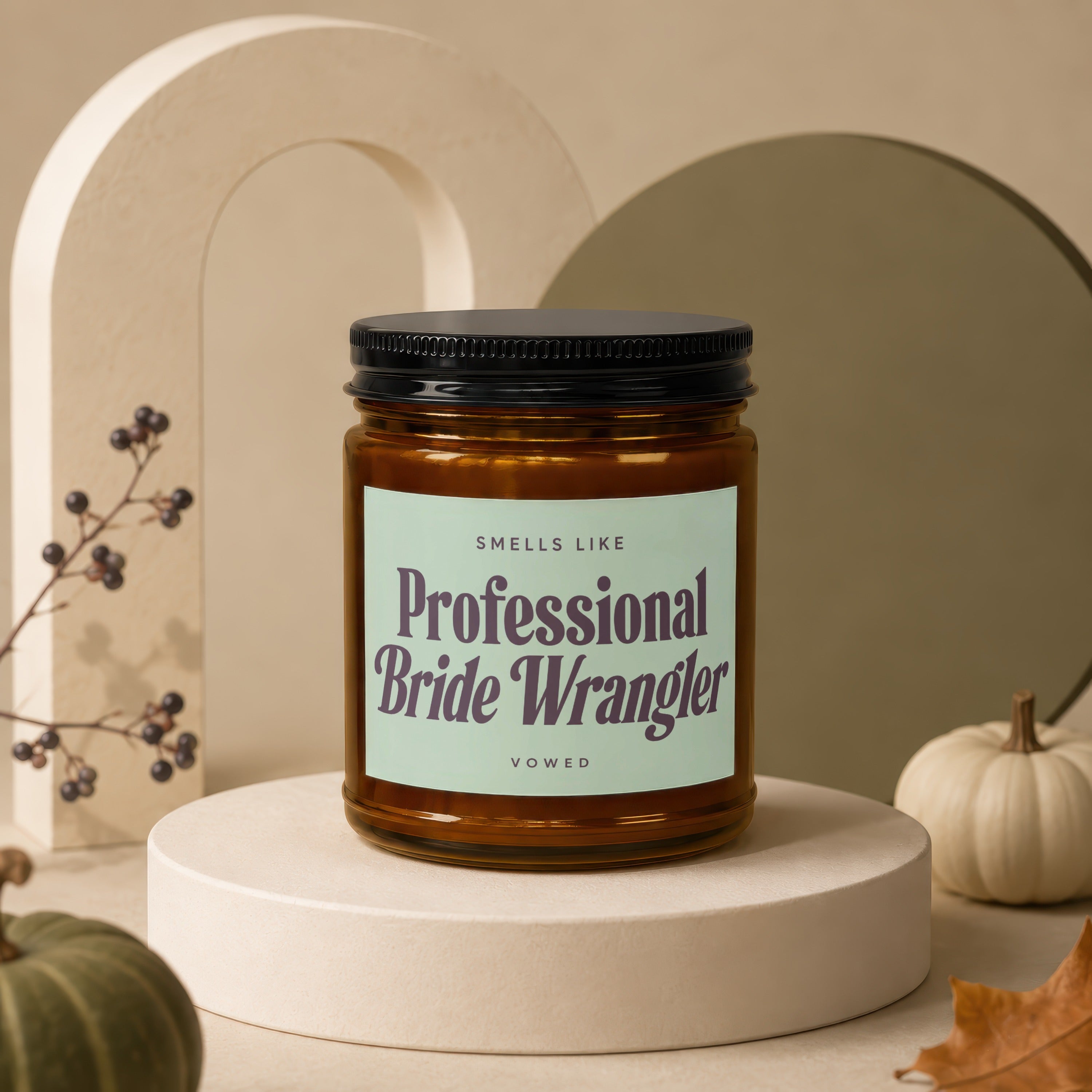 Candle with "Smells Like Professional Bride Wrangler" text on label.