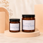 Two amber glass candles with black lids reading "I Can't, I'm Getting Married."