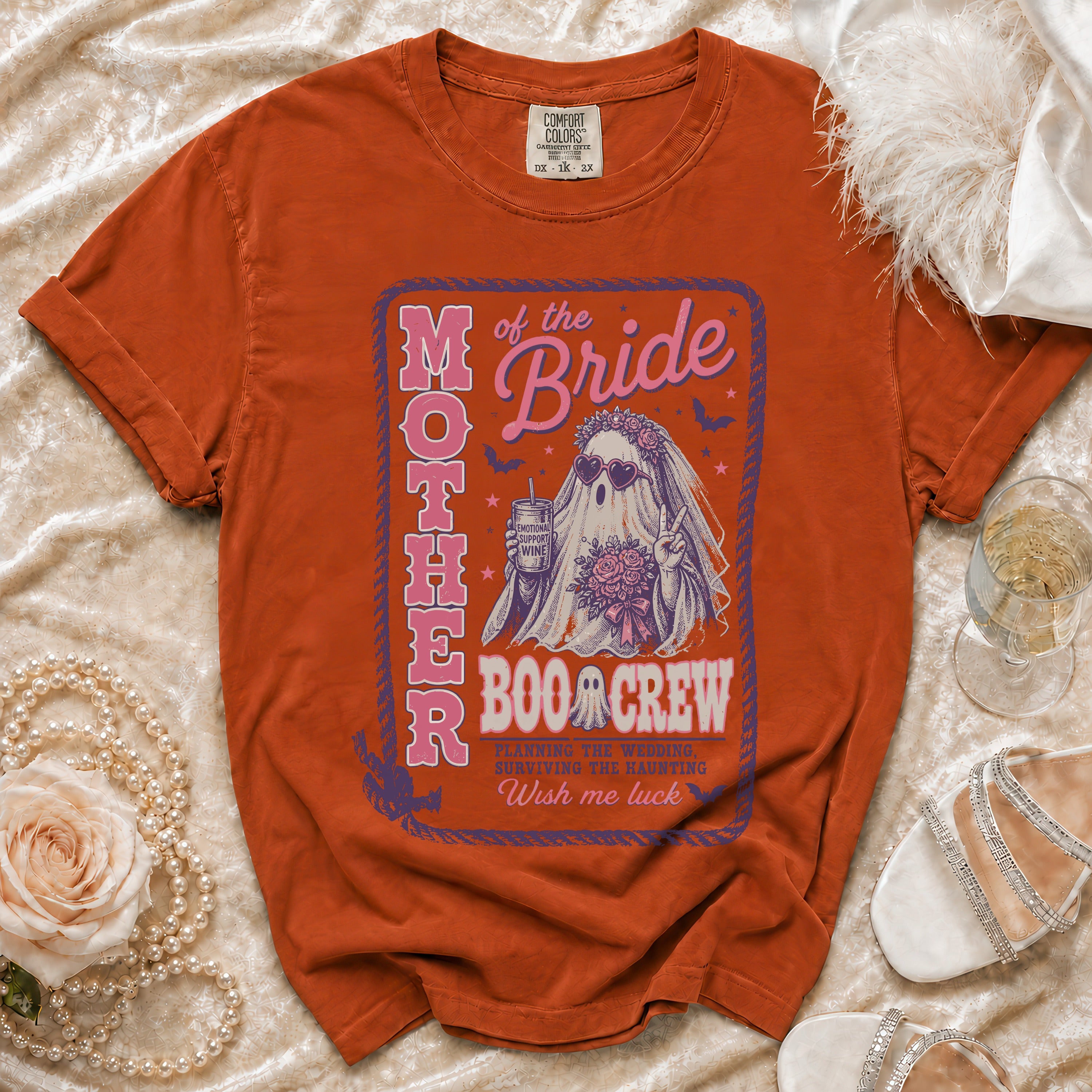 Orange t-shirt with "Mother of the Bride Boo Crew" Halloween ghost graphic.