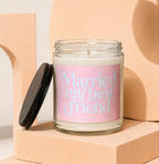 Candle with pink label reading "Married my best friend VOWED" on a light orange block.