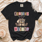 Black t-shirt with cartoon raccoons wearing wedding attire and text "MARRIED my favorite WEIRDO".