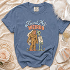 Blue t-shirt with Bigfoot in a wedding veil and an alien in a suit, reading "Found My Weirdo."