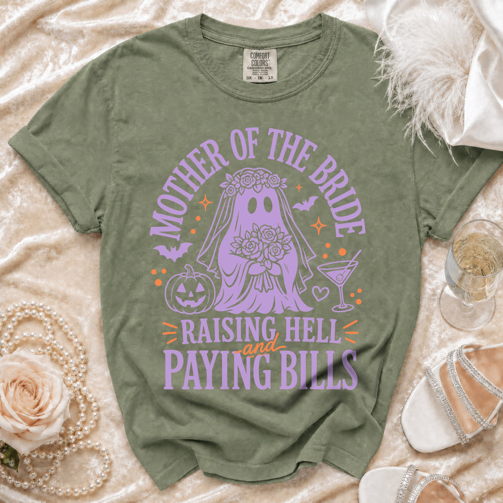 Olive green t-shirt with purple ghost bride graphic and text: "Mother of the Bride Raising Hell and Paying Bills."