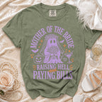 Olive green t-shirt with purple ghost bride graphic and text: "Mother of the Bride Raising Hell and Paying Bills."