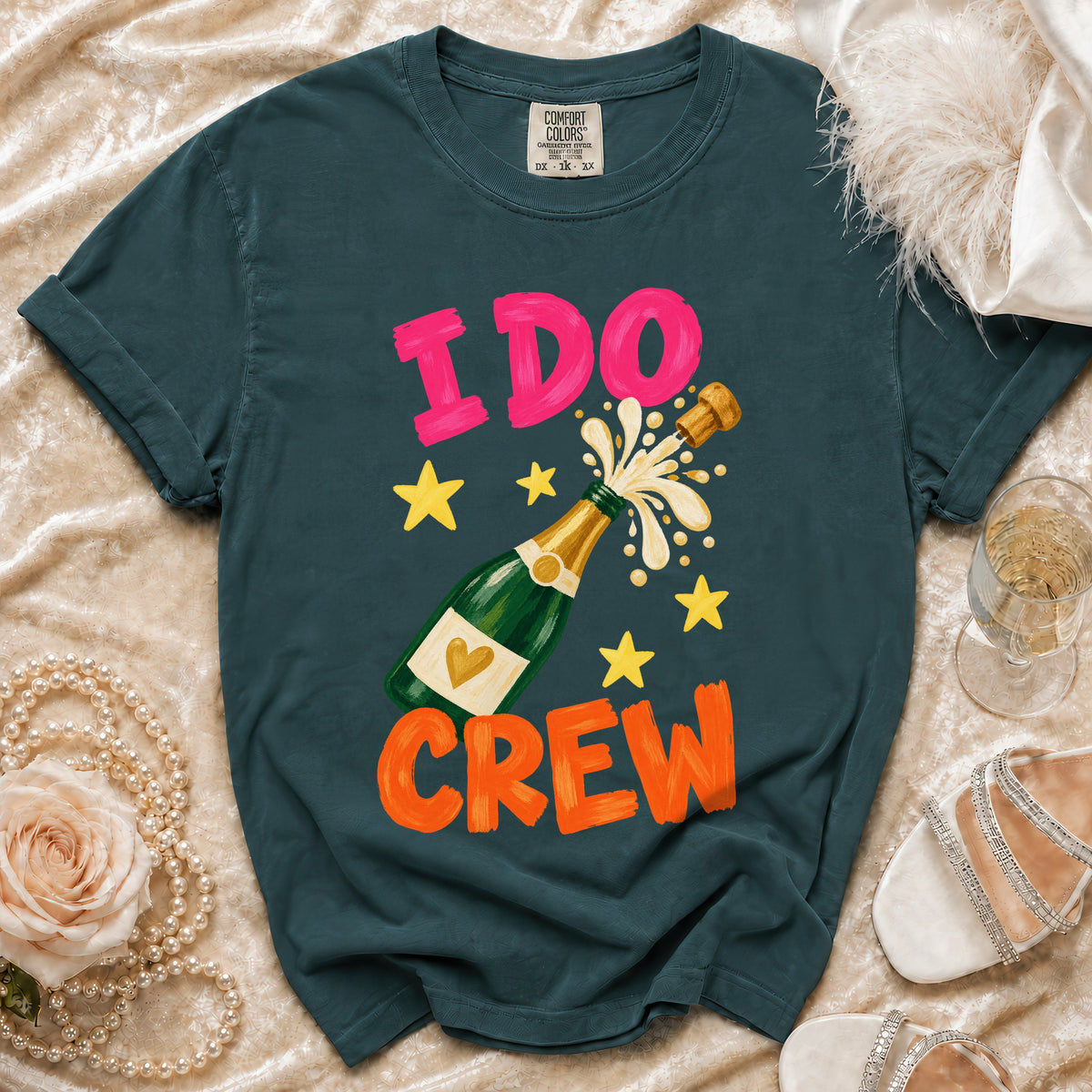 Green t-shirt with "I DO CREW" text, champagne bottle, and stars graphic.