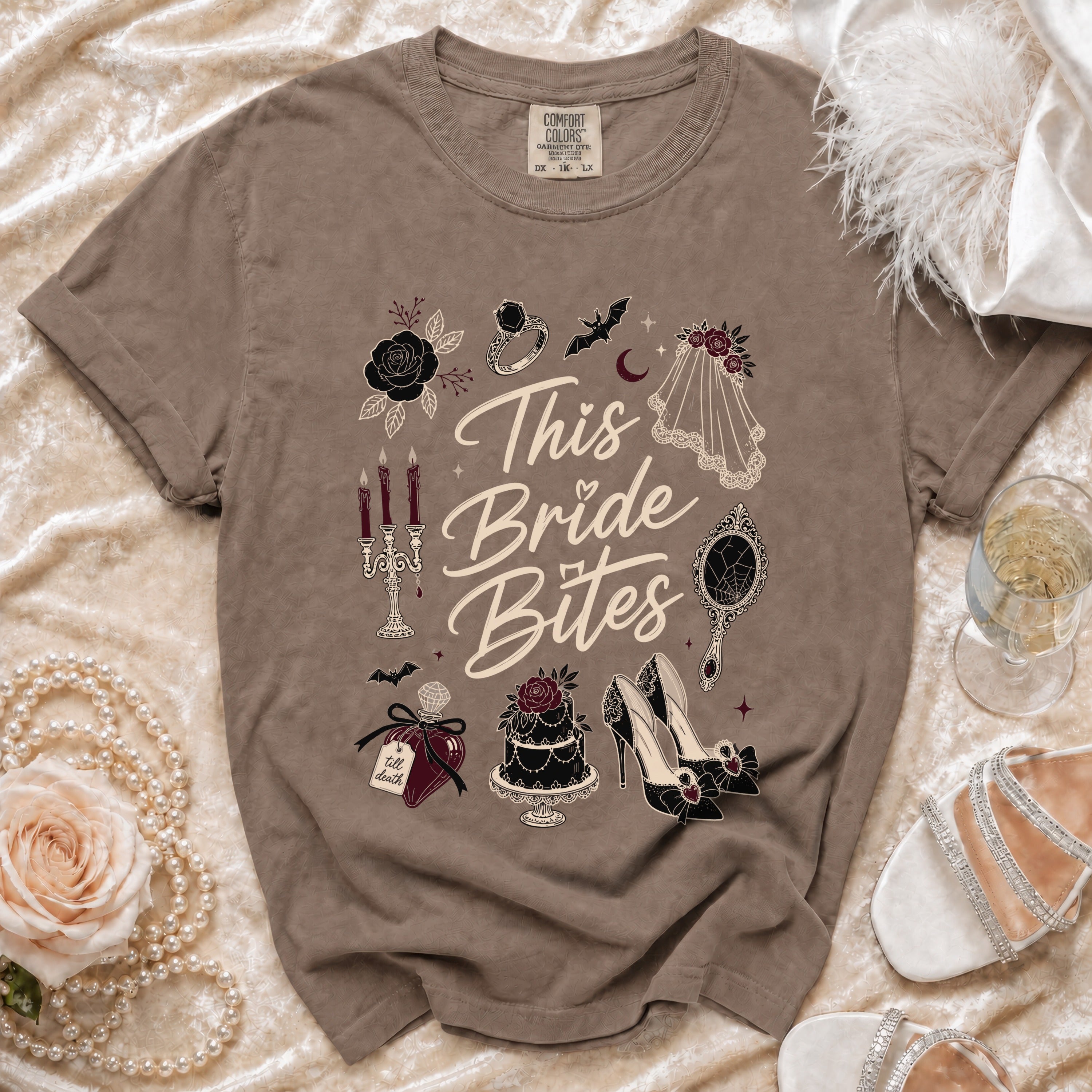 Brown t-shirt with "This Bride Bites" graphic, ring, bat, and cake.