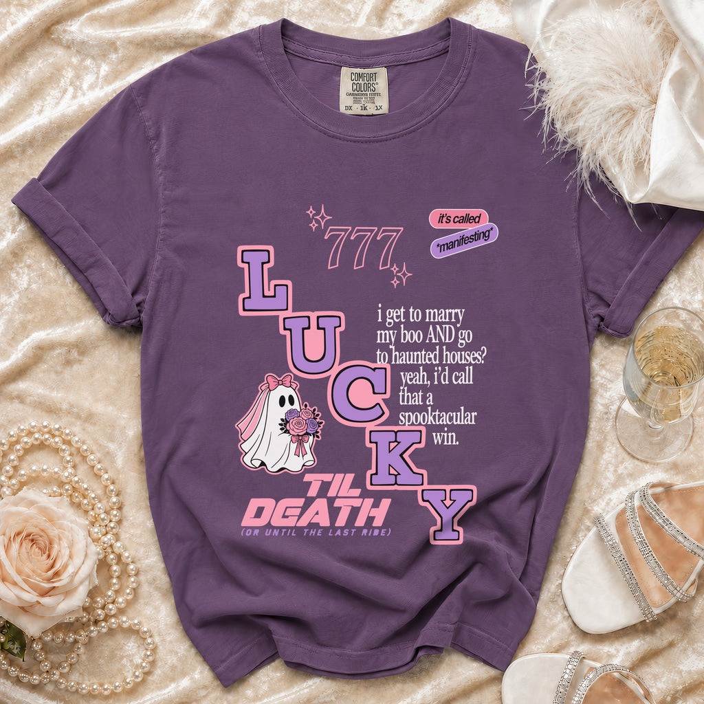 Purple t-shirt with "Lucky" graphic, ghost bride, and romantic spooky text.