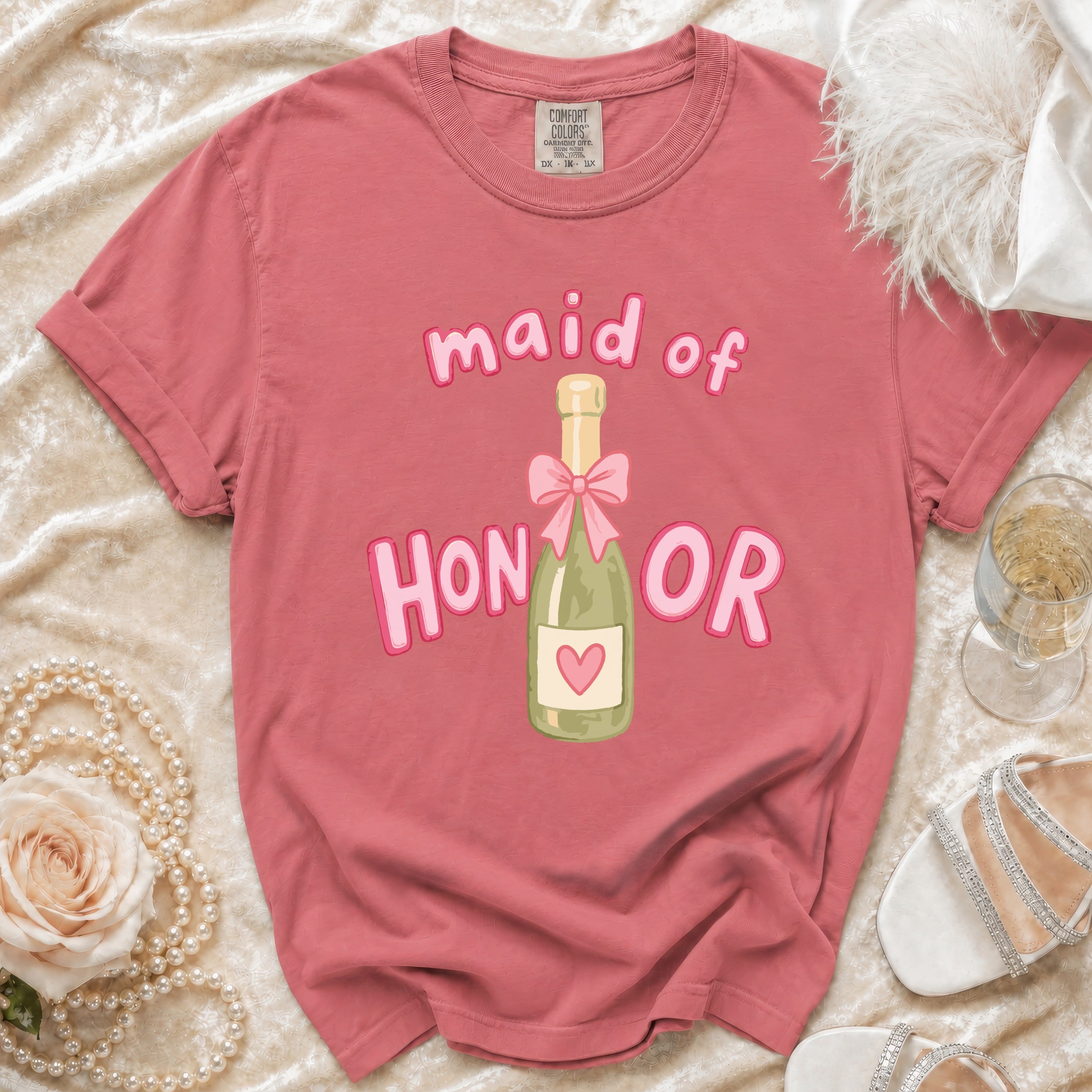 Pink t-shirt with "Maid of Honor" text and champagne bottle graphic.