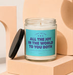 Soy wax candle with teal label reading "All the Joy in the World to You Both."