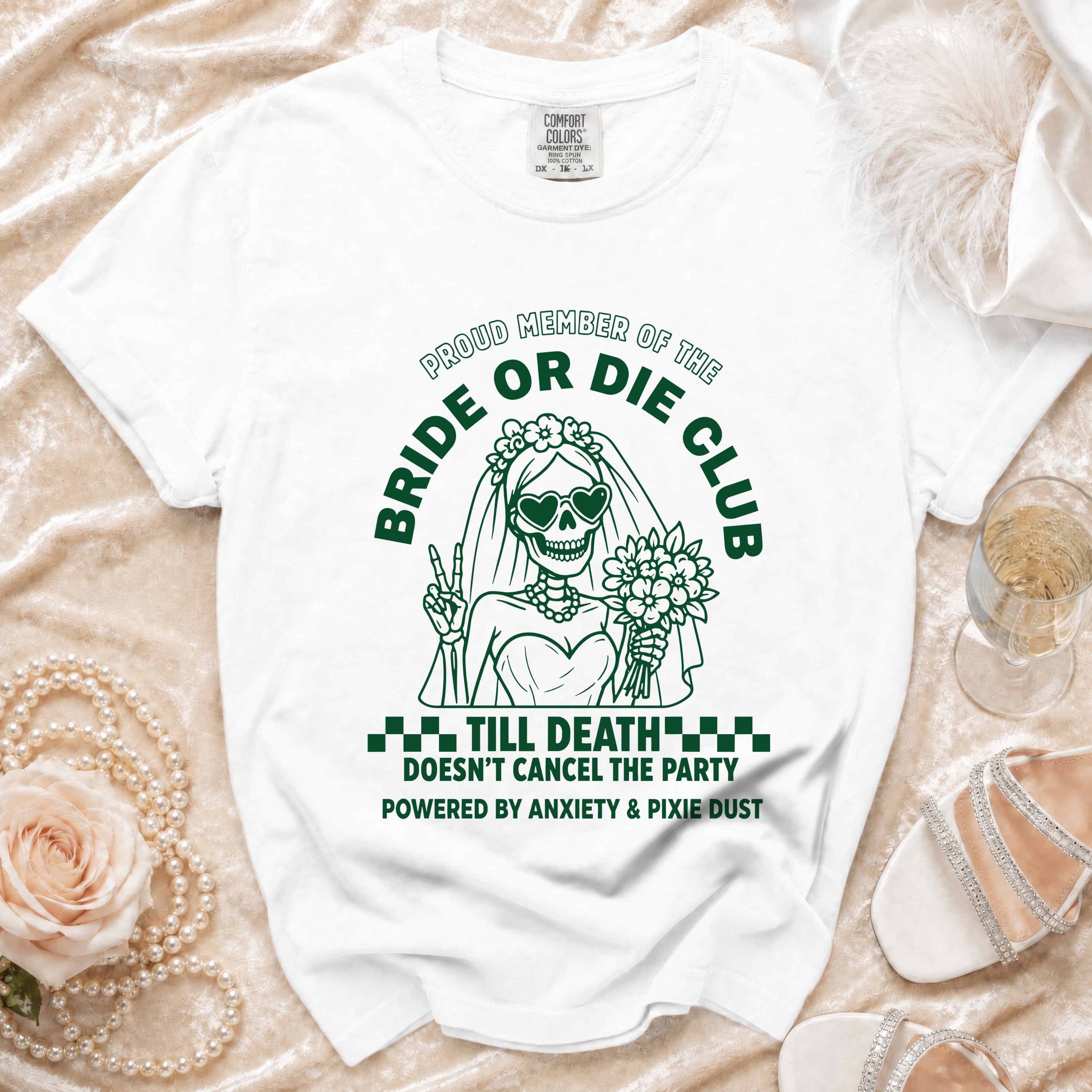 White t-shirt with green text and graphics of a skeleton bride, "Bride or Die Club".
