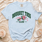 Light blue t-shirt with "BOUQUET TOSS CLUB" text and a pink bouquet graphic.