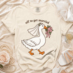 Cream t-shirt with a cartoon goose wearing a veil and holding flowers, text reads "off to get married".