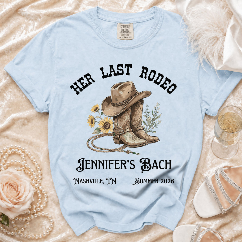 Light blue t-shirt with "Her Last Rodeo Jennifer's Bach" graphic.
