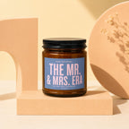 Amber candle with a blue label reading "THE MR. & MRS. ERA".