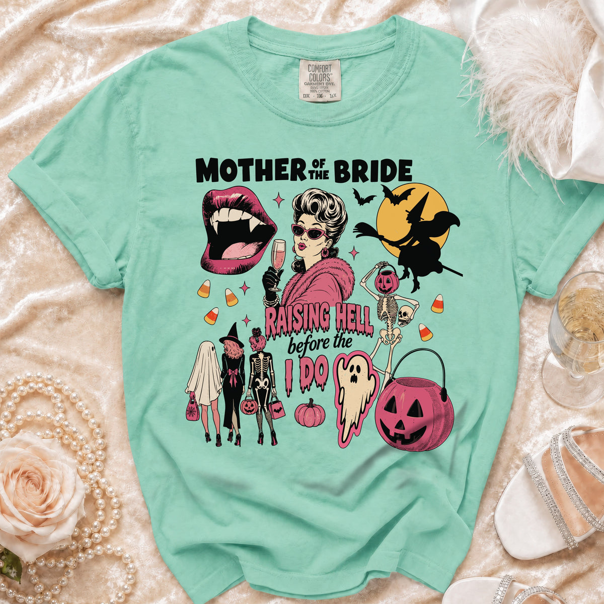 Mint t-shirt with "Mother of the Bride Raising Hell before the I Do" Halloween graphic.