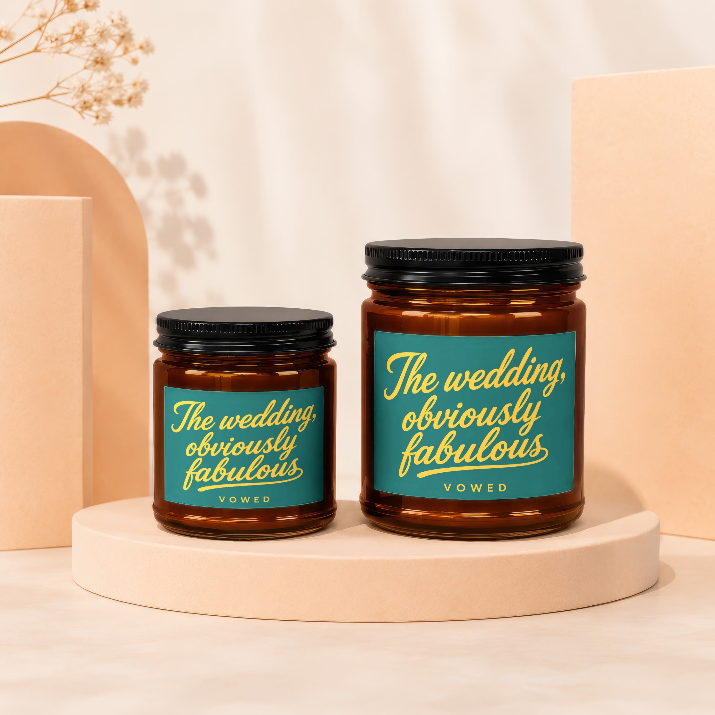 Two amber glass jar candles with "The wedding, obviously fabulous" text.