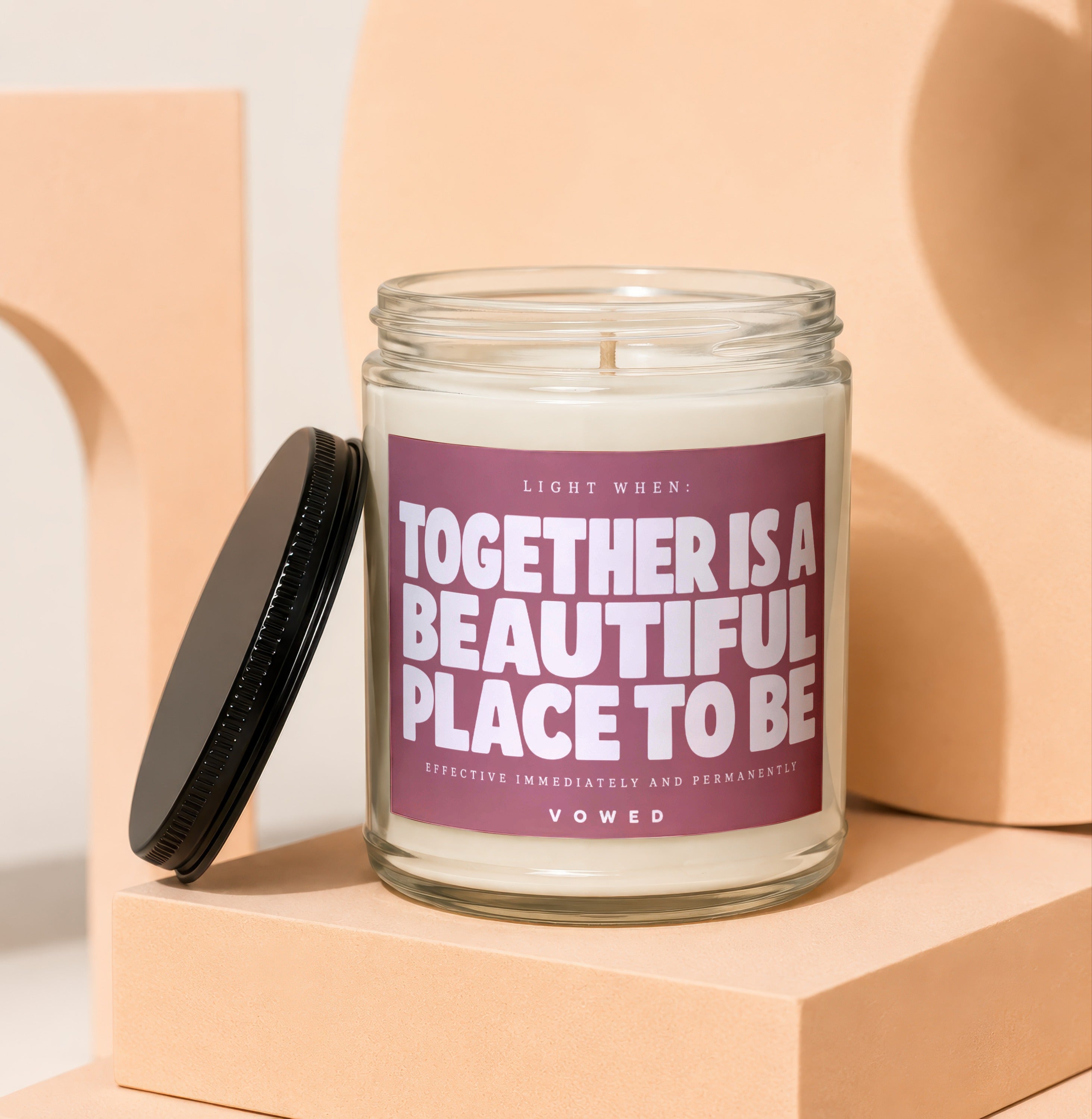 Glass candle with maroon label reading "Together Is A Beautiful Place To Be Vowed."