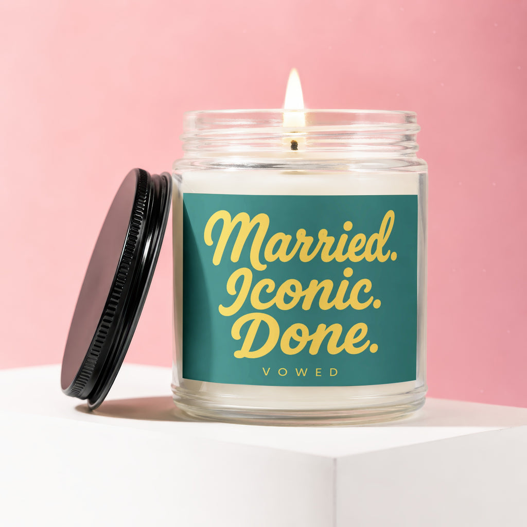 Candle with black lid titled "Married. Iconic. Done. VOWED." on teal label.