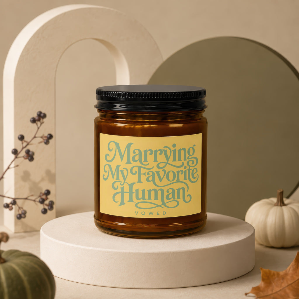 Amber candle in glass jar with black lid, reads "Marrying My Favorite Human".
