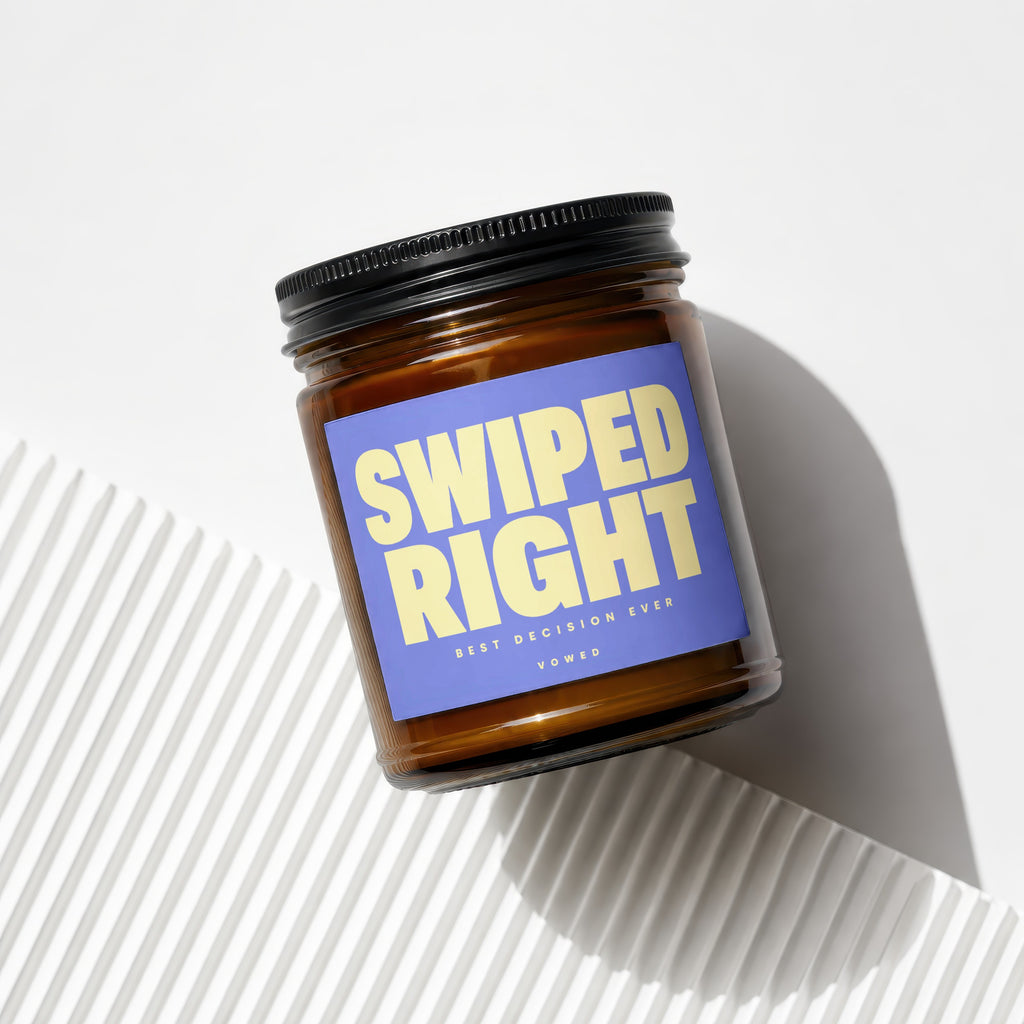 Amber jar candle with blue label reading "SWIPED RIGHT BEST DECISION EVER VOWED".