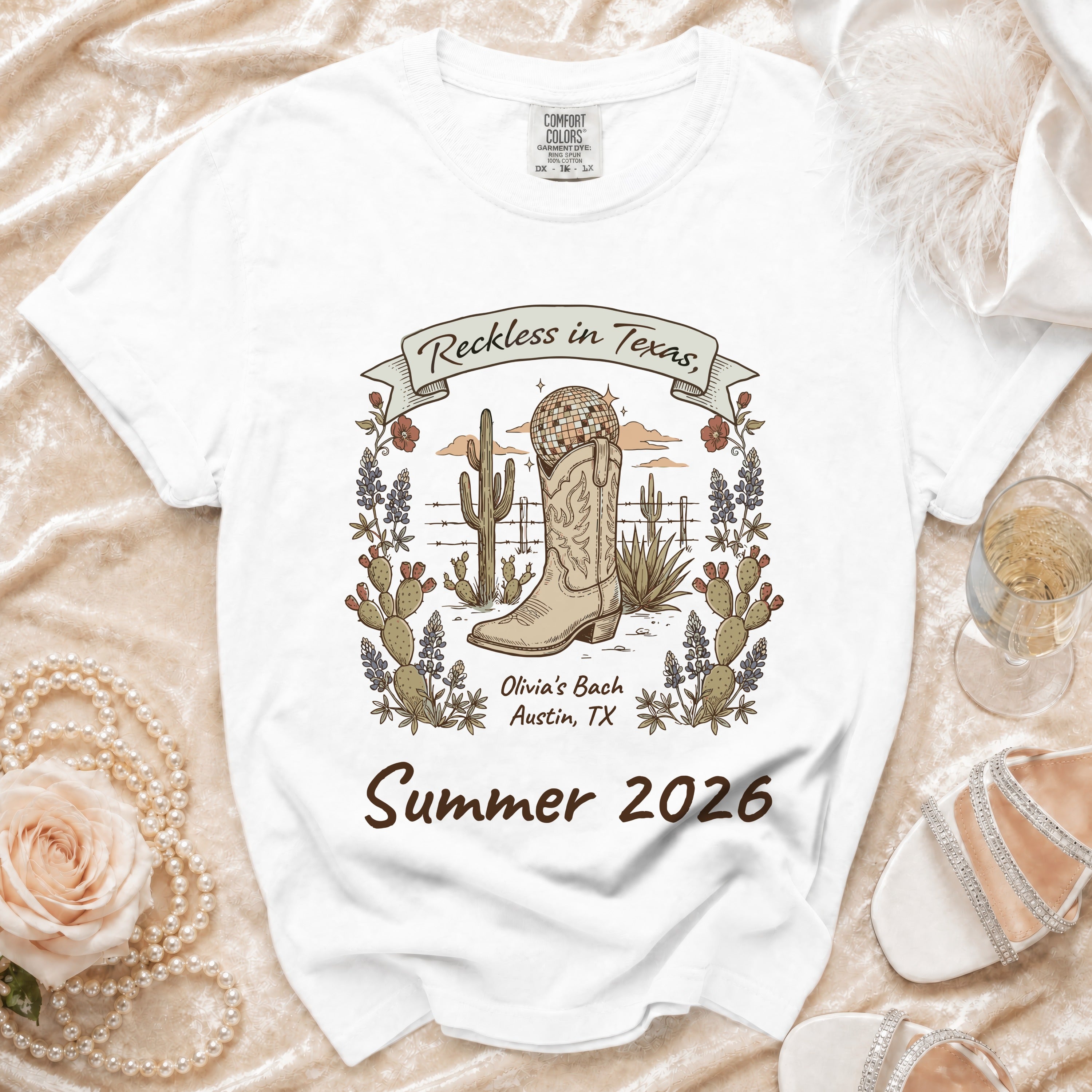 White t-shirt with "Reckless in Texas" and desert boot graphic.