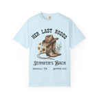 Light blue t-shirt with cowboy boots, hat, and lasso graphic for Jennifer's Bach Nashville Summer 2026.